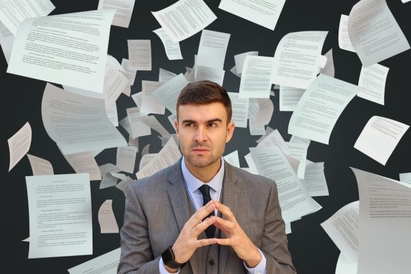 Businessman surrounded by flying documents